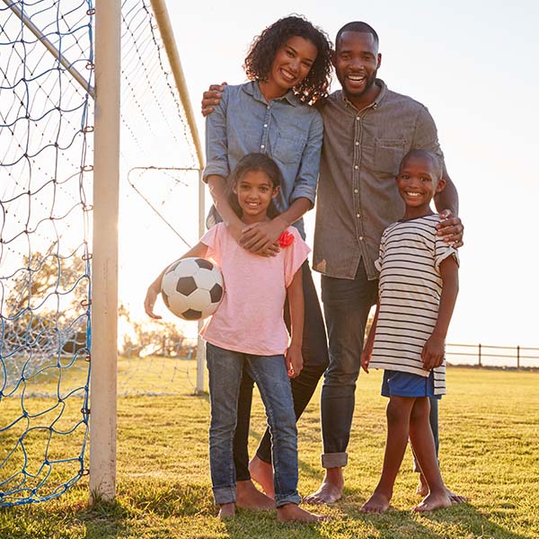 portrait-of-a-young-black-family-during-a-football-2021-08-26-16-14-03-utc